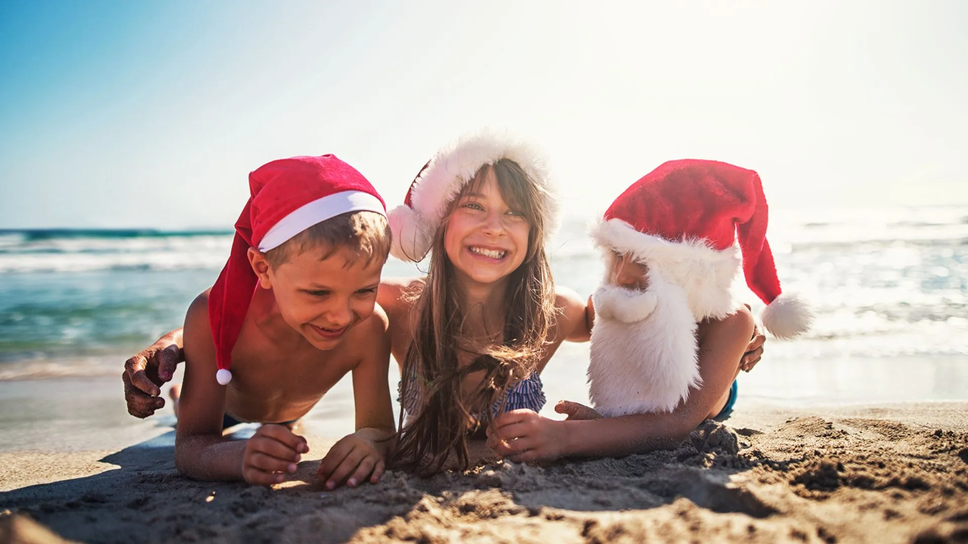 kids on beach whisper their stocking stuffers ideas