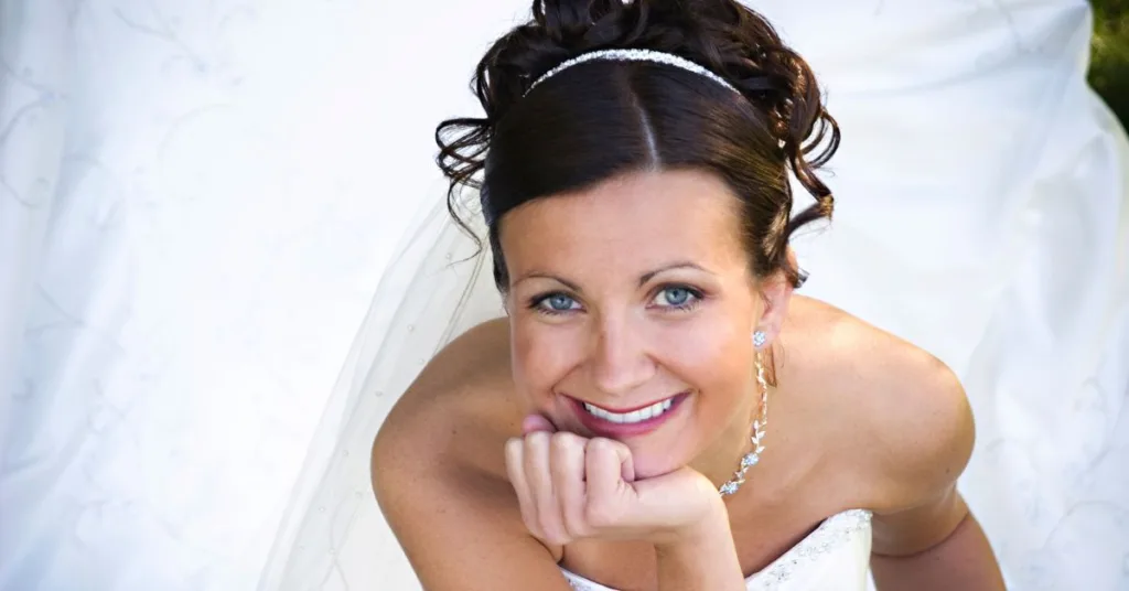 bride smiles in her wedding dress after using the fastest way to straighten teeth before wedding