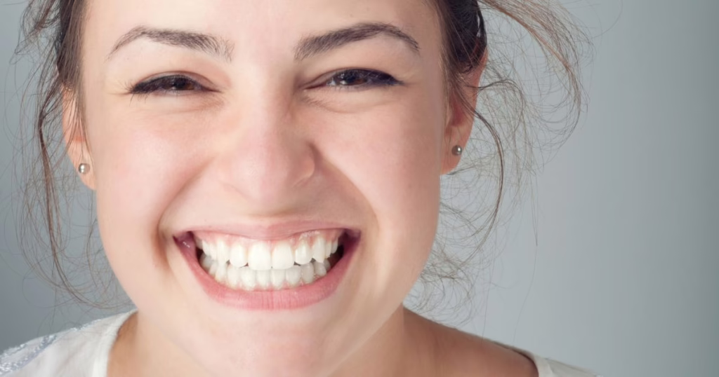 adult smiles after learning How to Clean Invisalign